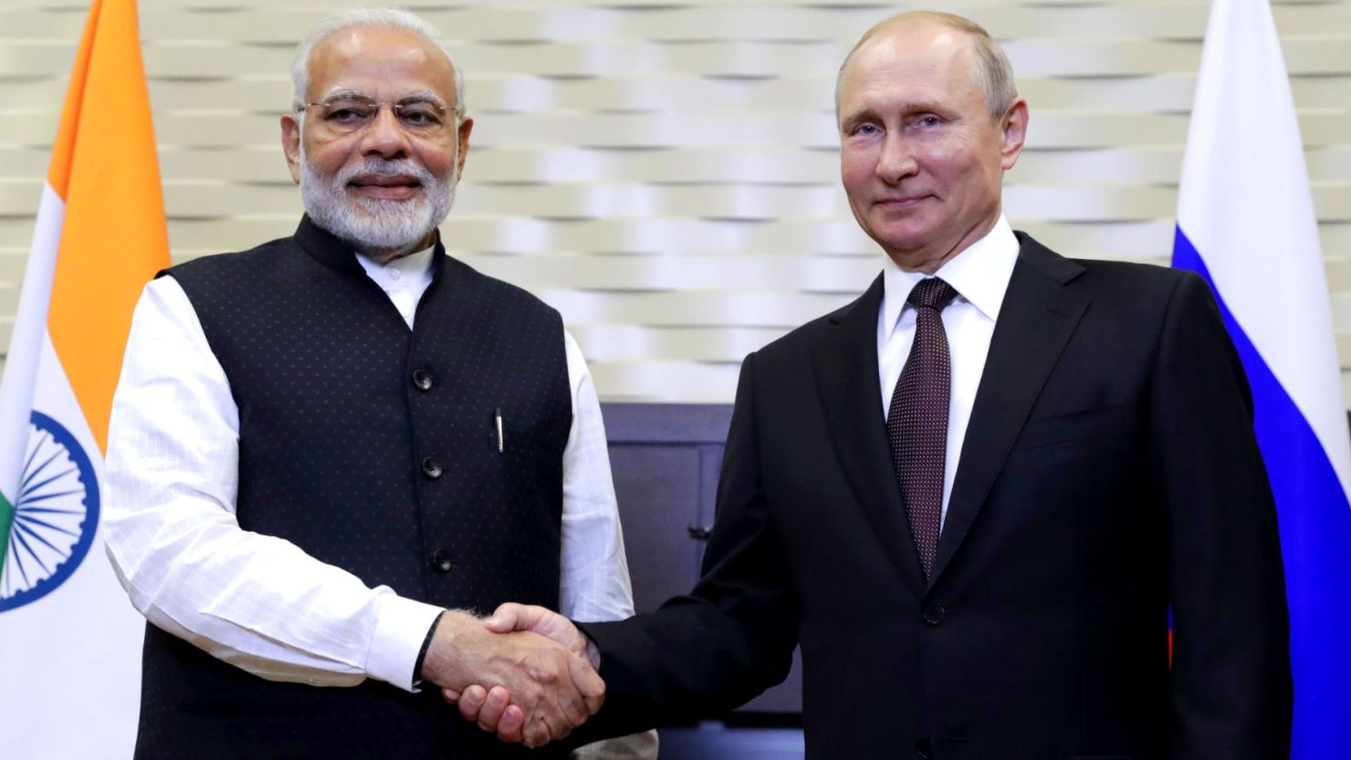 Executives from Reliance and Rosneft shaking hands 