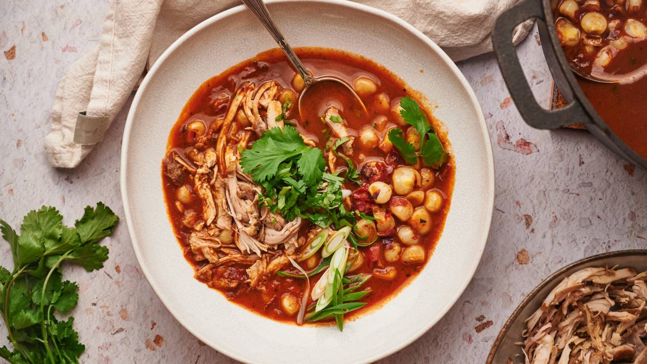 Traditional pozole blanco with hominy and pork in a clear broth