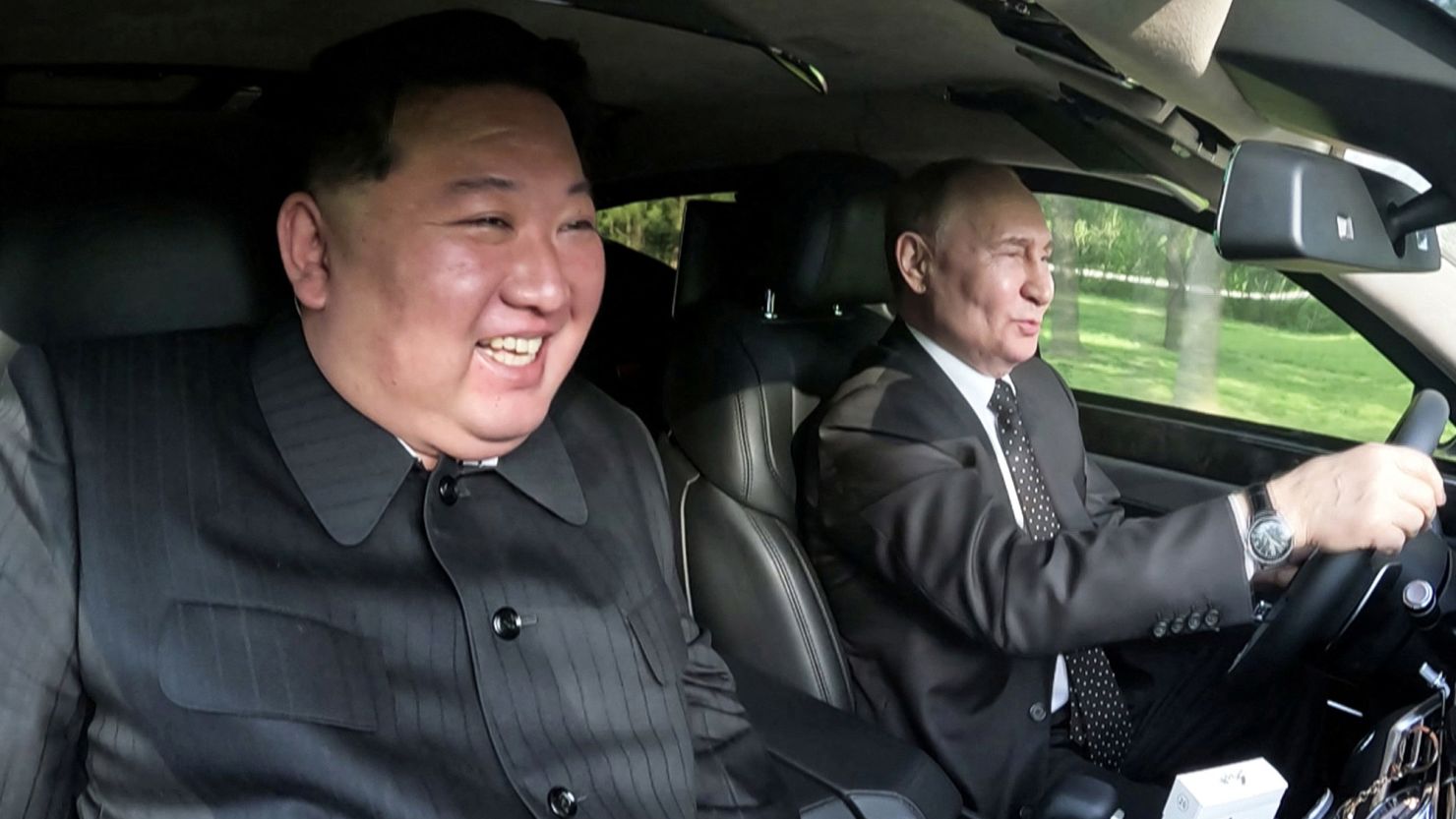 North Korean and Russian flags displayed prominently during the leaders' meeting. 