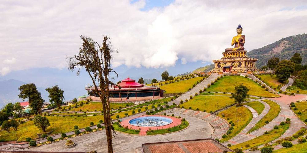 Khecheopalri Lake with clear blue waters and prayer flags fluttering