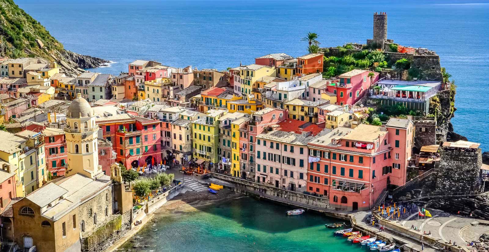 Breathtaking view of Vernazza's harbor and pastel-colored buildings at sunset