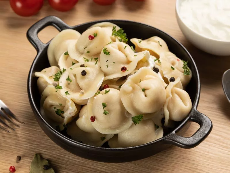 Fresh ingredients for making pelmeni, including dough and minced meat 