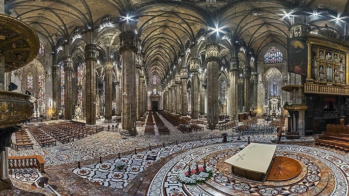 The magnificent interior of Duomo di Milano with soaring ceilings. 